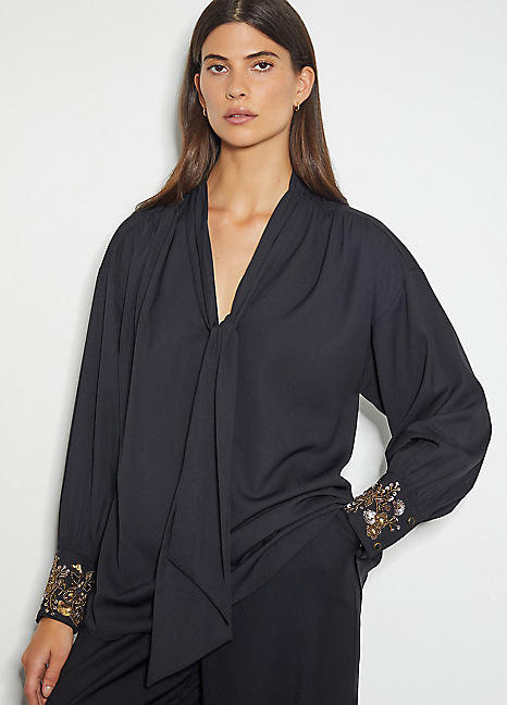 black jumper with sequin sleeves